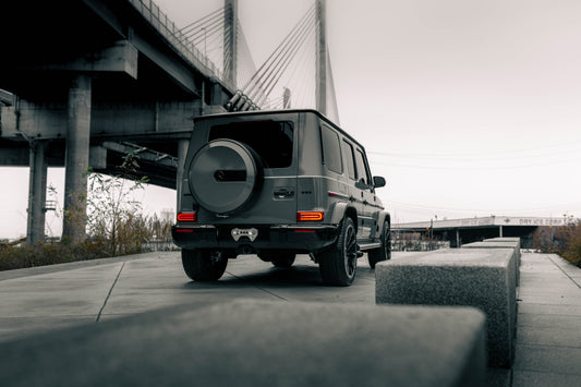 Mercedes Benz sitting in a scenic spot, looking over a bridge.